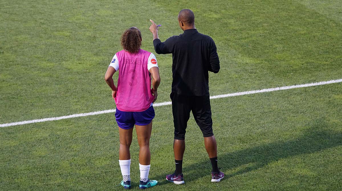 Soccer player and coach on field